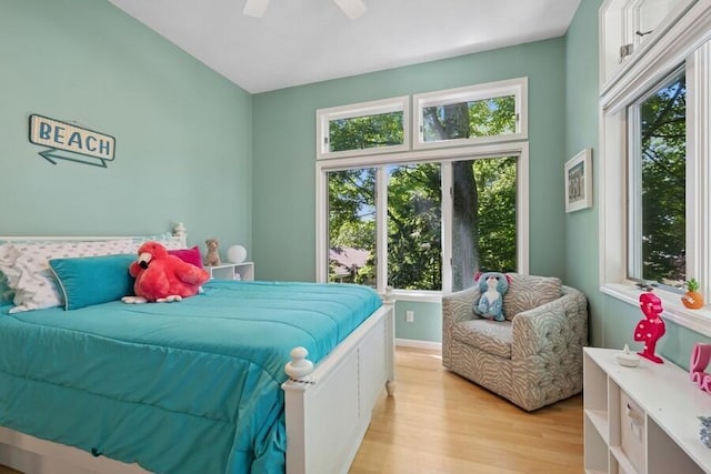 613 Indian Trl, Sawyer, MI 49125 - bedroom featuring multiple windows, light wood finished floors, and ceiling fan