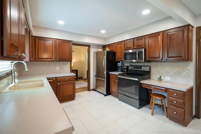 2934 Meadowbrook Dr SE, Grand Rapids, MI 49546 - kitchen featuring stainless steel appliances, light countertops, decorative backsplash, an office area, and recessed lighting