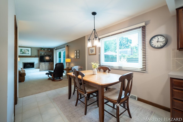2934 Meadowbrook Dr SE, Grand Rapids, MI 49546 - dining area with a brick fireplace and light carpet