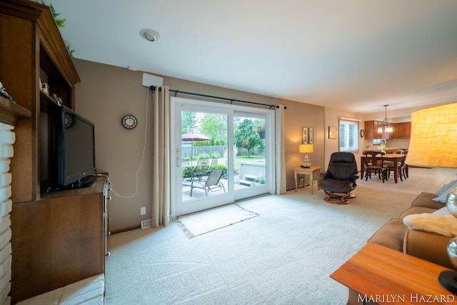 2934 Meadowbrook Dr SE, Grand Rapids, MI 49546 - living area featuring light colored carpet and a chandelier