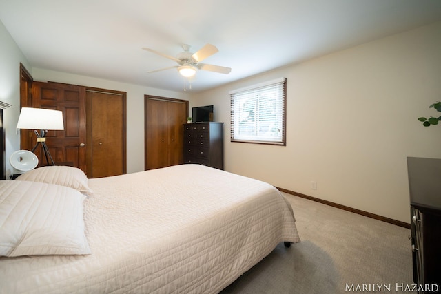 2934 Meadowbrook Dr SE, Grand Rapids, MI 49546 - bedroom featuring multiple closets, light carpet, and a ceiling fan