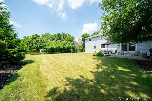 2934 Meadowbrook Dr SE, Grand Rapids, MI 49546 - view of green lawn with a patio