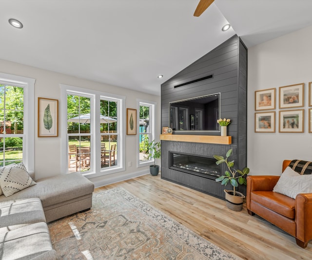 820 Barton Dr, Ann Arbor, MI 48105 - living room featuring wood finished floors, a large fireplace, recessed lighting, and lofted ceiling
