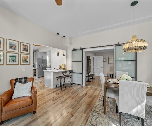 820 Barton Dr, Ann Arbor, MI 48105 - dining area with a barn door, light wood-style floors, and ceiling fan