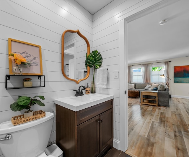 820 Barton Dr, Ann Arbor, MI 48105 - bathroom with wood finished floors, vanity, and wood walls