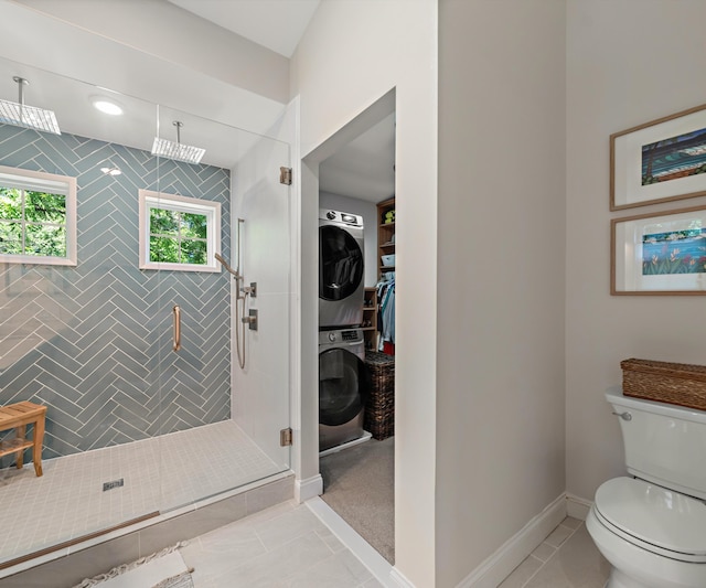 820 Barton Dr, Ann Arbor, MI 48105 - bathroom featuring stacked washing machine and dryer, a shower stall, and a walk in closet