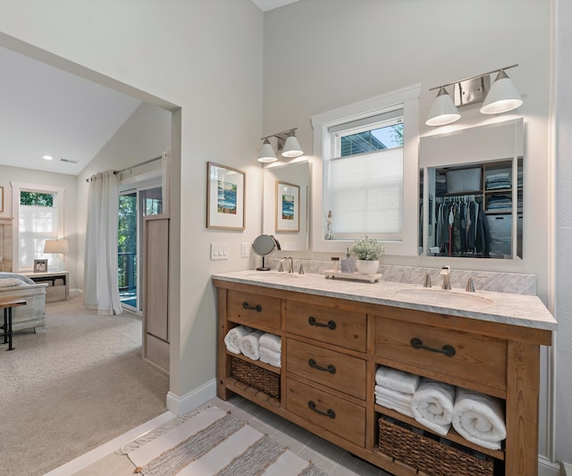820 Barton Dr, Ann Arbor, MI 48105 - full bathroom featuring double vanity, high vaulted ceiling, and a walk in closet
