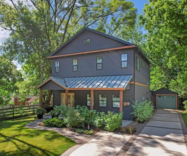 820 Barton Dr, Ann Arbor, MI 48105 - view of front of property with a standing seam roof, covered porch, an outbuilding, concrete driveway, and a garage