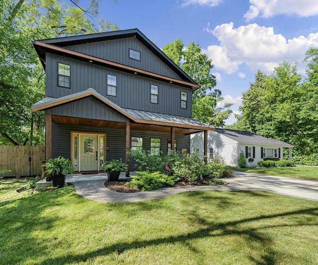 820 Barton Dr, Ann Arbor, MI 48105 - view of front of house with driveway, a standing seam roof, covered porch, and a metal roof