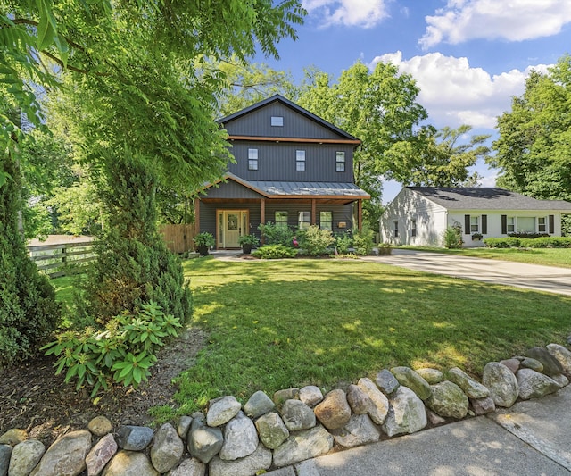 820 Barton Dr, Ann Arbor, MI 48105 - view of front of property featuring covered porch, concrete driveway, a metal roof, and a standing seam roof