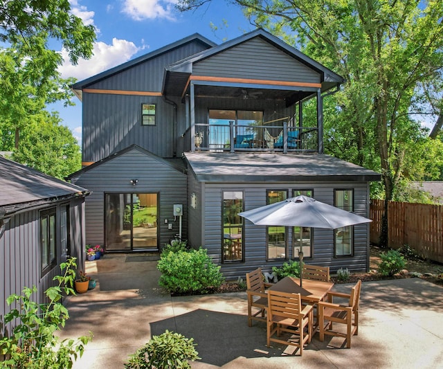820 Barton Dr, Ann Arbor, MI 48105 - rear view of house featuring a balcony, a patio, and board and batten siding