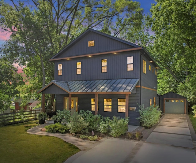 820 Barton Dr, Ann Arbor, MI 48105 - view of front of home featuring a standing seam roof, covered porch, an outbuilding, concrete driveway, and a garage