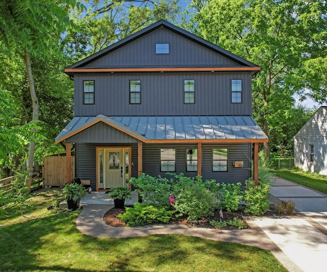 820 Barton Dr, Ann Arbor, MI 48105 - view of front of house featuring a standing seam roof, covered porch, a metal roof, and concrete driveway