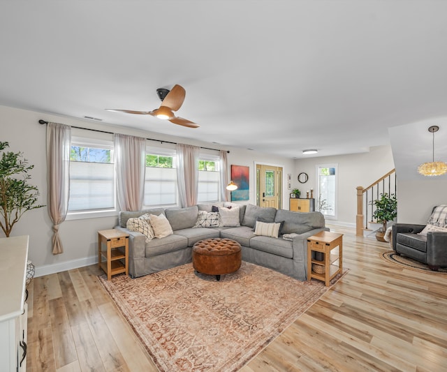 820 Barton Dr, Ann Arbor, MI 48105 - living room featuring light wood-type flooring, ceiling fan, and stairway