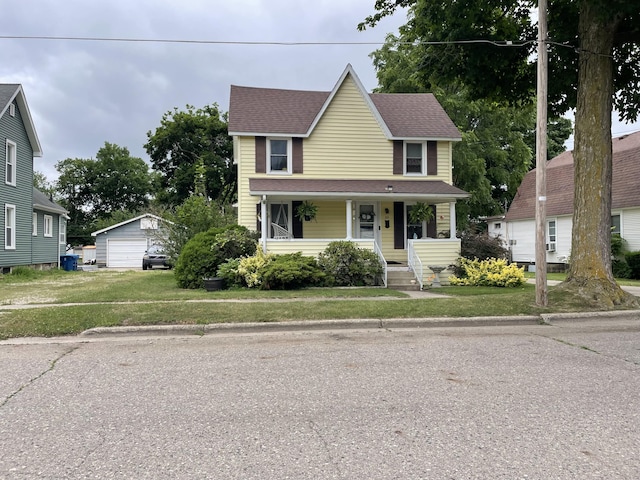 33 Abbott Ave, Coldwater, MI 49036 - traditional home with a garage, a porch, an outdoor structure, and a front lawn