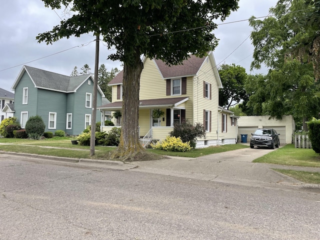 33 Abbott Ave, Coldwater, MI 49036 - view of front facade with covered porch, an outdoor structure, and a front yard