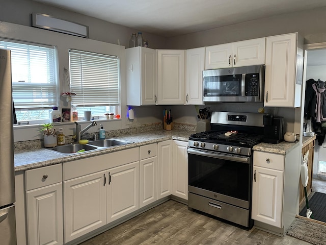 33 Abbott Ave, Coldwater, MI 49036 - kitchen with appliances with stainless steel finishes, plenty of natural light, white cabinetry, and light countertops