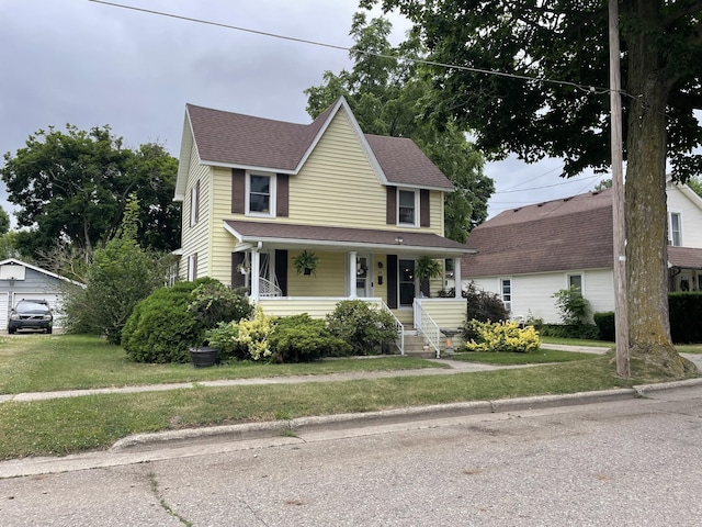 33 Abbott Ave, Coldwater, MI 49036 - view of front of house with a porch, a front lawn, and a shingled roof