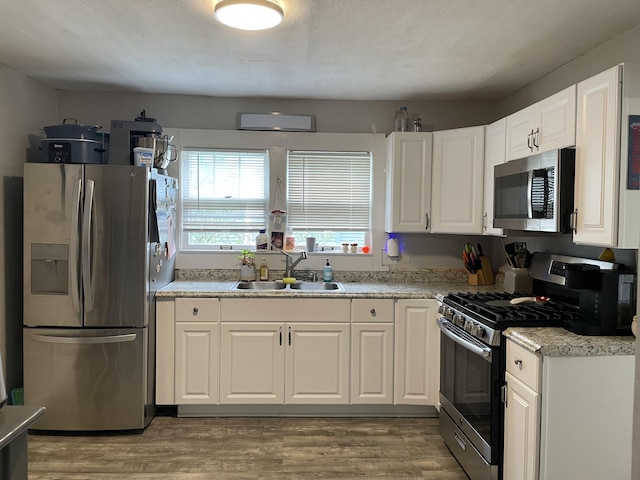 33 Abbott Ave, Coldwater, MI 49036 - kitchen with appliances with stainless steel finishes, white cabinetry, light wood finished floors, and light countertops