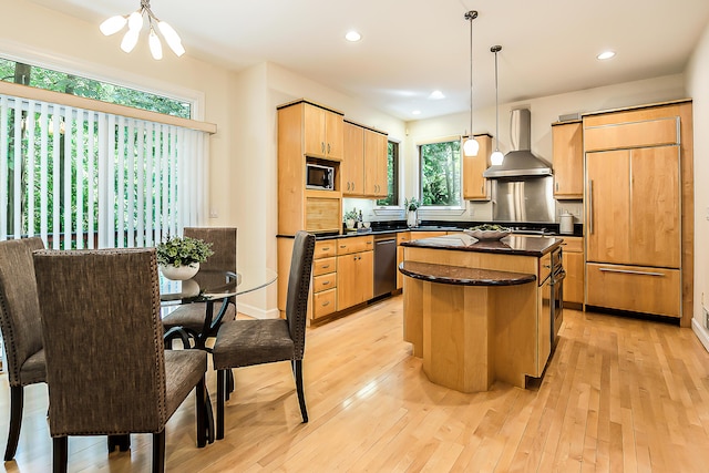 1544 Newport Creek Dr, Ann Arbor, MI 48103 - kitchen featuring wall chimney range hood, paneled refrigerator, dishwasher, a chandelier, and dark countertops