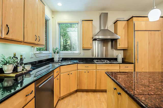 1544 Newport Creek Dr, Ann Arbor, MI 48103 - kitchen with wall chimney range hood, stainless steel appliances, light wood-style floors, dark stone countertops, and pendant lighting