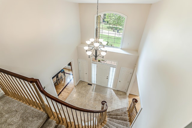 1544 Newport Creek Dr, Ann Arbor, MI 48103 - foyer featuring a chandelier, stairway, and a high ceiling
