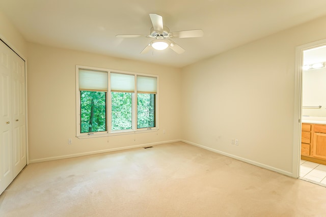 1544 Newport Creek Dr, Ann Arbor, MI 48103 - unfurnished bedroom featuring light colored carpet, a closet, ensuite bathroom, and a ceiling fan