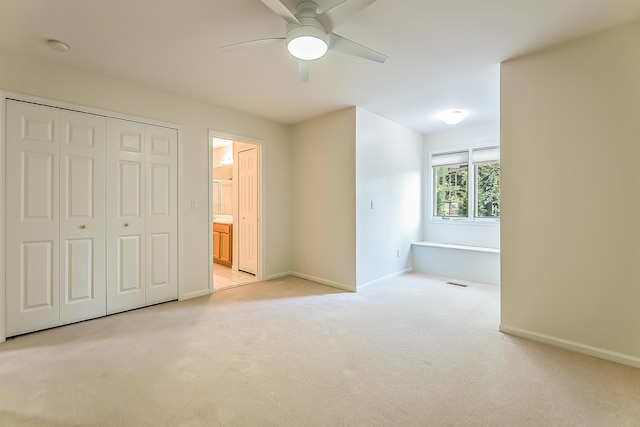 1544 Newport Creek Dr, Ann Arbor, MI 48103 - unfurnished bedroom featuring light carpet, a closet, ensuite bathroom, and a ceiling fan