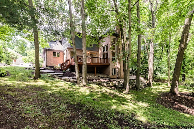 1544 Newport Creek Dr, Ann Arbor, MI 48103 - back of house featuring a deck, stairs, brick siding, and a lawn