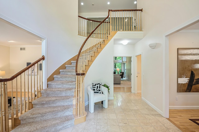 1544 Newport Creek Dr, Ann Arbor, MI 48103 - stairway with a high ceiling, ornamental molding, and recessed lighting