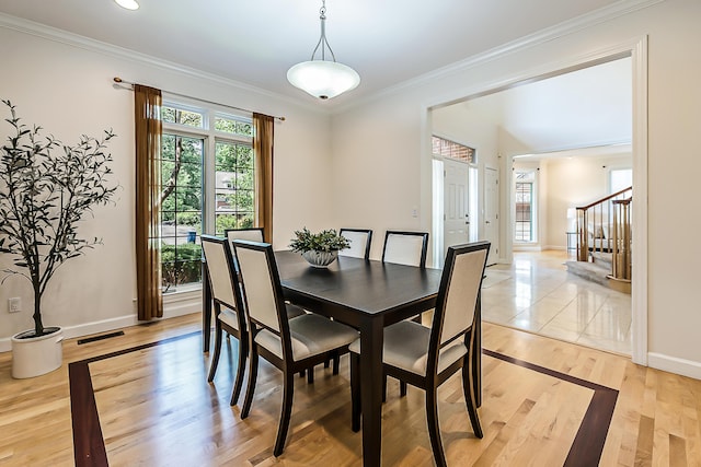 1544 Newport Creek Dr, Ann Arbor, MI 48103 - dining area featuring healthy amount of natural light, stairs, ornamental molding, and light wood finished floors