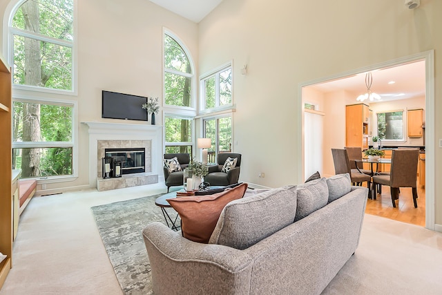 1544 Newport Creek Dr, Ann Arbor, MI 48103 - living area with a towering ceiling, a fireplace, a chandelier, and carpet