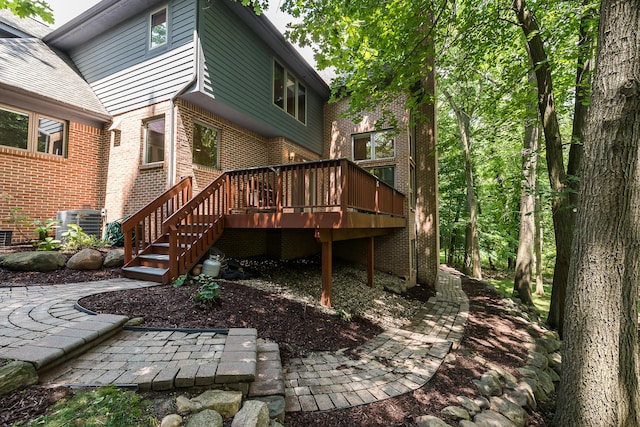 1544 Newport Creek Dr, Ann Arbor, MI 48103 - back of property featuring brick siding, a wooden deck, and stairway