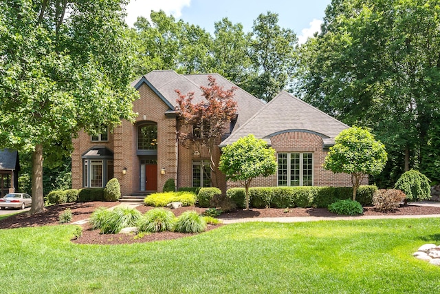 1544 Newport Creek Dr, Ann Arbor, MI 48103 - view of front facade featuring brick siding, a front lawn, and roof with shingles