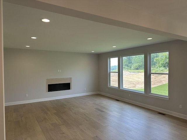 3490 Mare Cir, Wixom, MI 48393 - unfurnished living room featuring a fireplace, wood finished floors, and recessed lighting