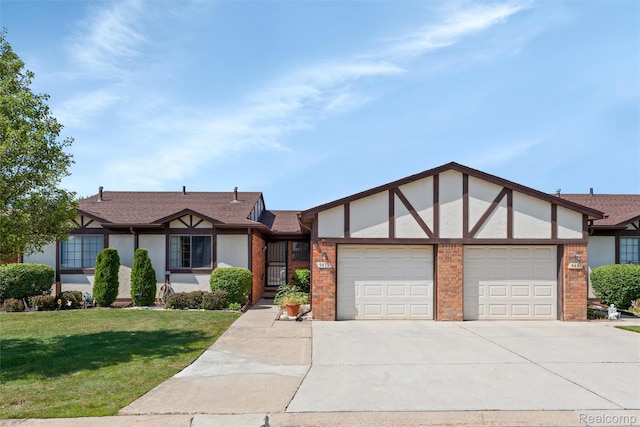 5419 Duke Ct, Warren, MI 48091 - english style home featuring a garage, stucco siding, concrete driveway, and a front yard