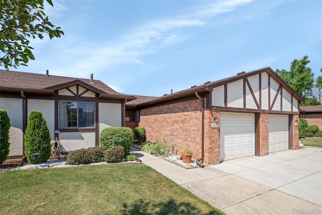 5419 Duke Ct, Warren, MI 48091 - tudor-style house featuring an attached garage, concrete driveway, stucco siding, a front lawn, and brick siding