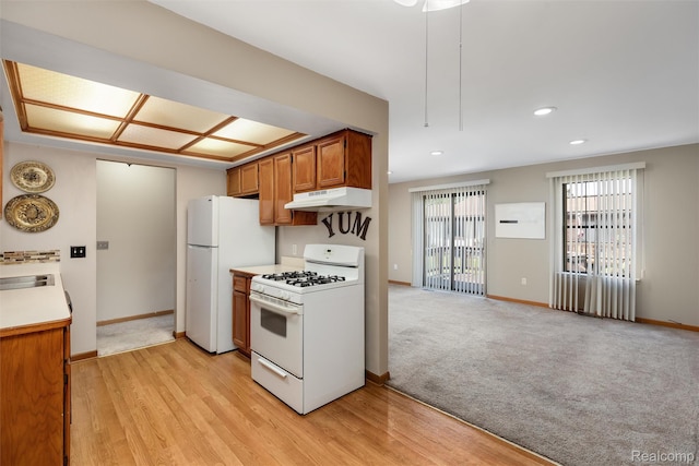 5419 Duke Ct, Warren, MI 48091 - kitchen featuring white appliances, under cabinet range hood, brown cabinets, light wood-type flooring, and recessed lighting