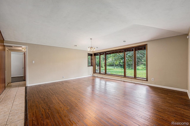 36680 Howard Rd, Farmington, MI 48331 - empty room with a chandelier and light wood finished floors