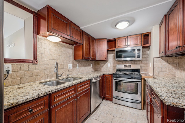 36680 Howard Rd, Farmington, MI 48331 - kitchen featuring stainless steel appliances, light tile patterned flooring, backsplash, and light stone counters