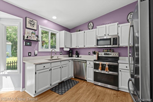 9125 Mandon Rd, White Lake, MI 48386 - kitchen with stainless steel appliances, light countertops, white cabinetry, and recessed lighting