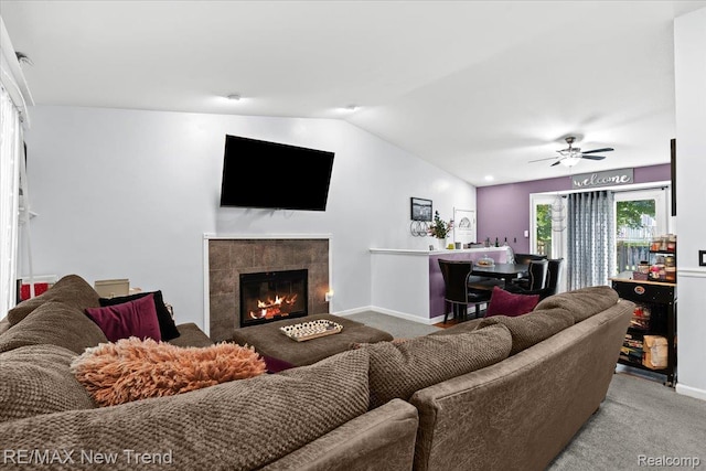 9125 Mandon Rd, White Lake, MI 48386 - carpeted living area with lofted ceiling, a ceiling fan, and a fireplace