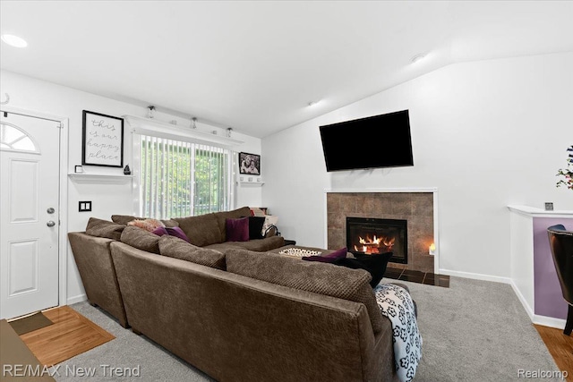9125 Mandon Rd, White Lake, MI 48386 - living area with lofted ceiling and a fireplace