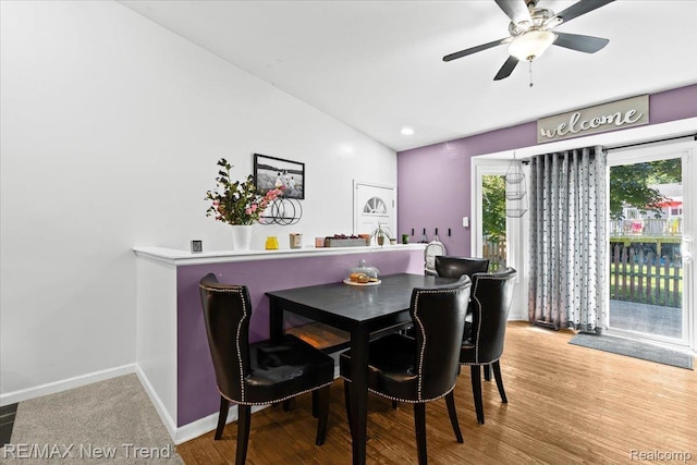 9125 Mandon Rd, White Lake, MI 48386 - dining area with wood finished floors, a ceiling fan, and vaulted ceiling