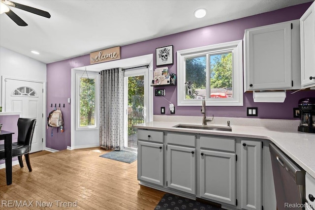 9125 Mandon Rd, White Lake, MI 48386 - kitchen with stainless steel dishwasher, light countertops, light wood-style floors, a ceiling fan, and recessed lighting