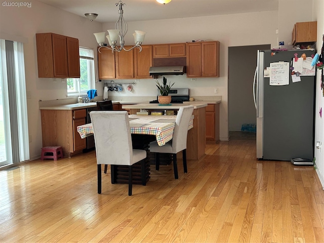 33555 Birchlawn, Westland, MI 48185 - kitchen with appliances with stainless steel finishes, under cabinet range hood, light wood-style floors, light countertops, and a chandelier