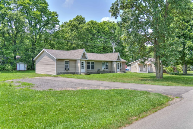 2922-2926 Chapel Rd, Parma, MI 49269 - ranch-style home featuring a shed, a front yard, and a shingled roof