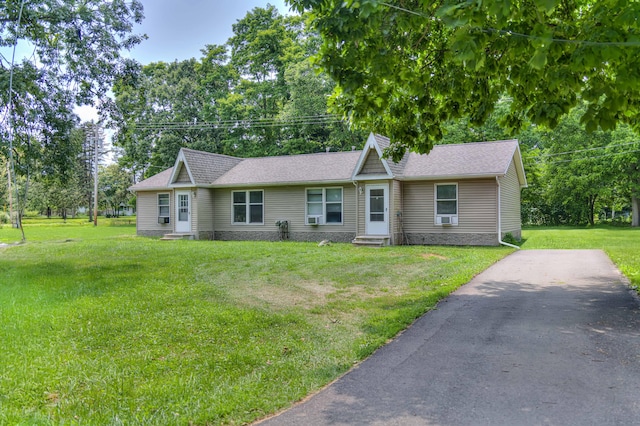 2922-2926 Chapel Rd, Parma, MI 49269 - ranch-style house featuring entry steps, a front yard, roof with shingles, view of wooded area, and driveway