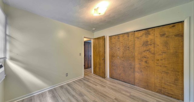 2922-2926 Chapel Rd, Parma, MI 49269 - unfurnished bedroom featuring light wood-style floors and a closet