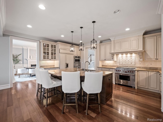 1200 Shipman Blvd, Birmingham, MI 48009 - kitchen featuring premium appliances, cream cabinets, an island with sink, backsplash, and recessed lighting